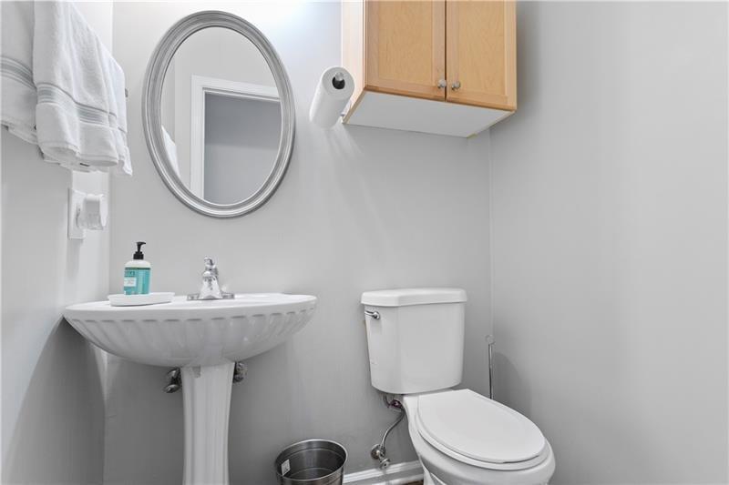 1150 Collier Road Northwest, Unit 3P Atlanta, GA 30318 - Photo 12 of 24 a bathroom with a toilet sink and mirror