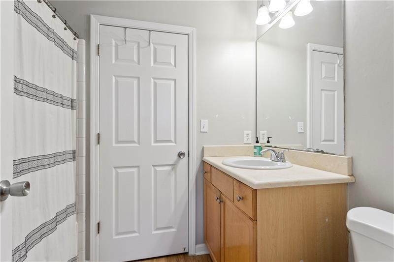 1150 Collier Road Northwest, Unit 3P Atlanta, GA 30318 - Photo 15 of 24 a bathroom with a sink and a mirror