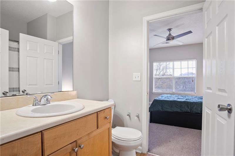 1150 Collier Road Northwest, Unit 3P Atlanta, GA 30318 - Photo 16 of 24 a bathroom with a sink a toilet a mirror and vanity