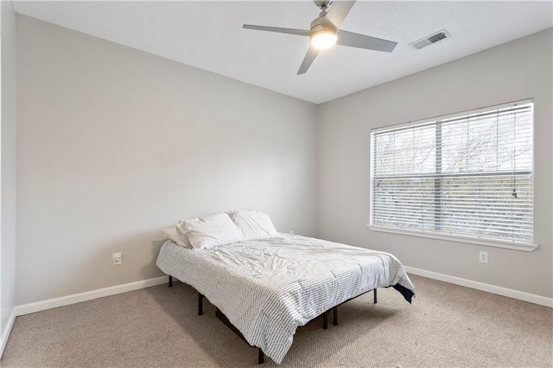 1150 Collier Road Northwest, Unit 3P Atlanta, GA 30318 - Photo 17 of 24 a bedroom with a bed and a window