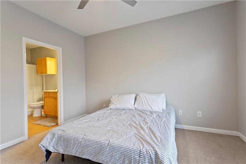 1150 Collier Road Northwest, Unit 3P Atlanta, GA 30318 - Photo 19 of 24 a bedroom with a bed and painting on the wall