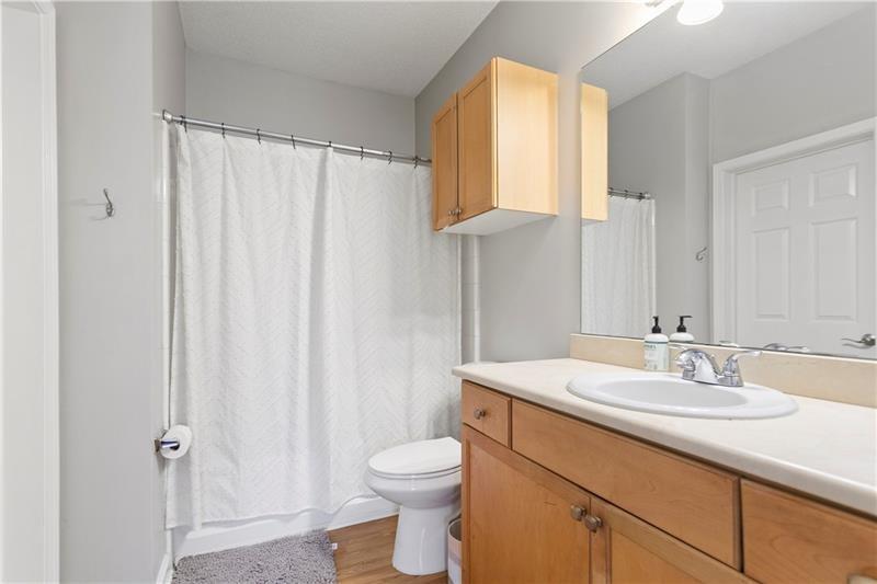 1150 Collier Road Northwest, Unit 3P Atlanta, GA 30318 - Photo 20 of 24 a bathroom with a sink a toilet and shower