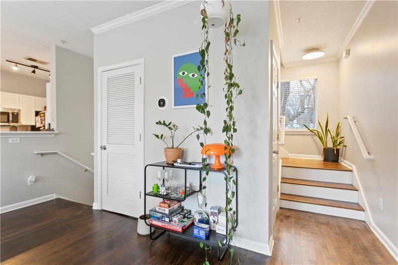1150 Collier Road Northwest, Unit 3P Atlanta, GA 30318 - Photo 2 of 24 a view of a hallway with wooden floor and dining area