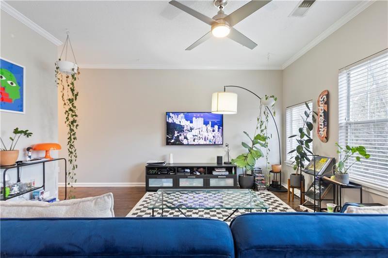1150 Collier Road Northwest, Unit 3P Atlanta, GA 30318 - Photo 5 of 24 a living room with furniture and a flat screen tv
