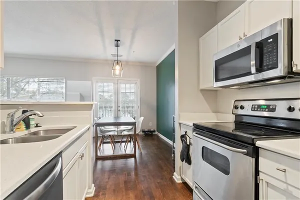 a kitchen with a stove a sink and a microwave