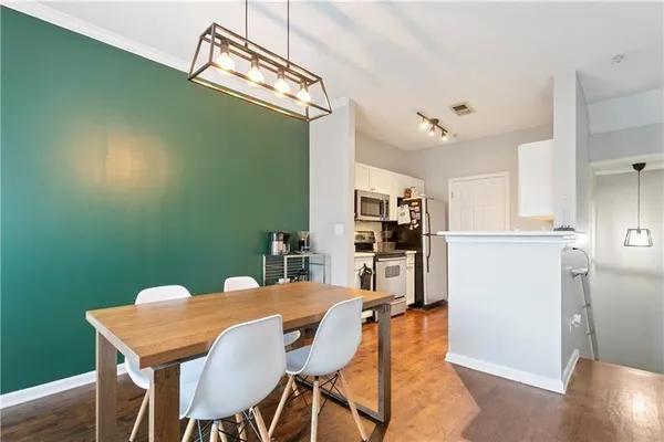 a view of a dining room with furniture and wooden floor