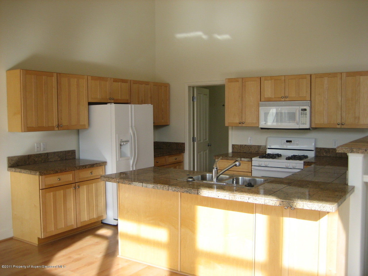 546 Evans Court Basalt, CO 81621 - Photo 4 of 6 a kitchen with granite countertop a refrigerator a stove a sink a counter space and cabinets