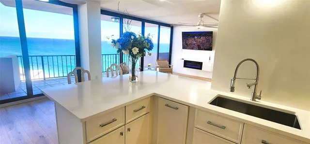 a kitchen with a sink a counter and cabinets