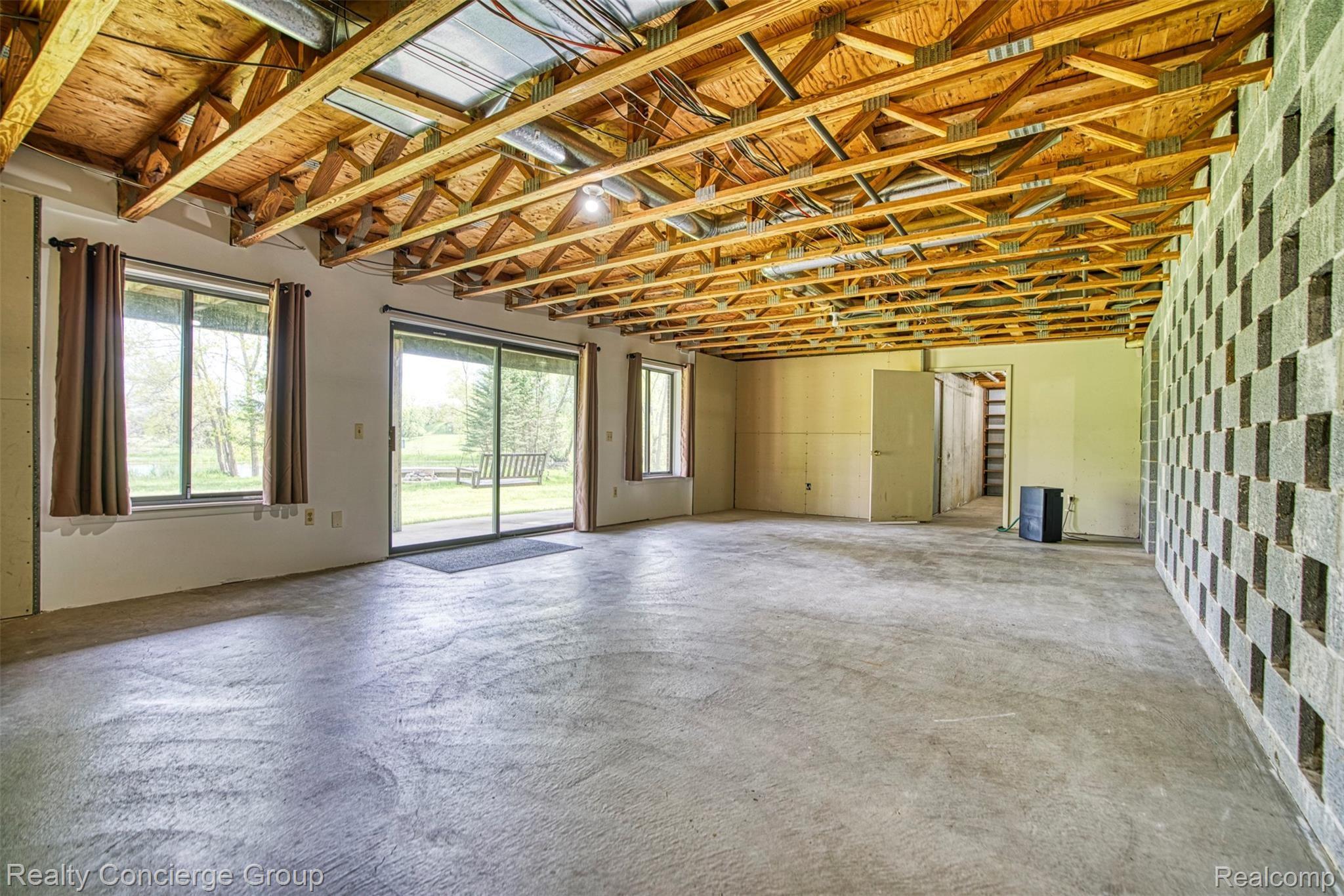 2110 East Clyde Road Howell, MI 48855 - Photo 18 of 44 Large windows and door wall create tons of natural lighting in this open space