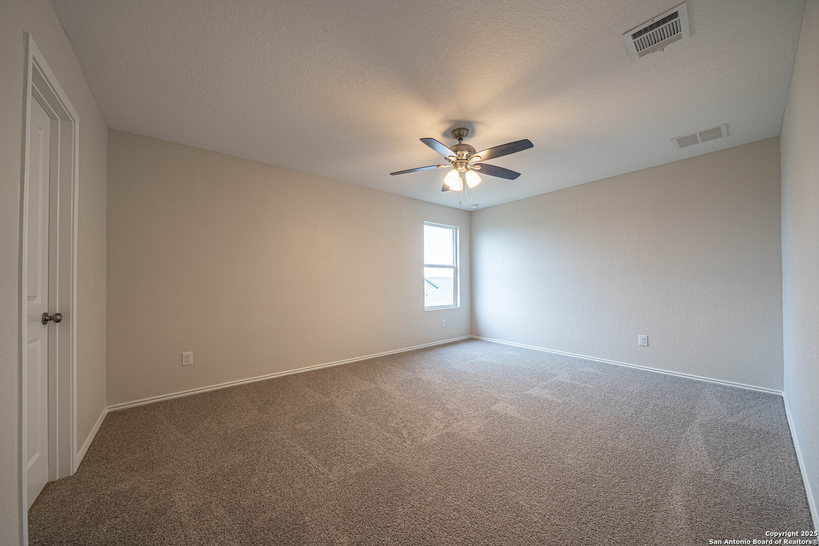 2818 Gustavo Drive Converse, TX 78109 - Photo 12 of 27 a view of an empty room with a chandelier fan