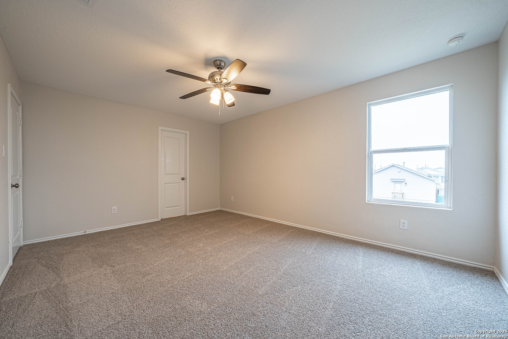 2818 Gustavo Drive Converse, TX 78109 - Photo 13 of 27 an empty room with a window and a ceiling fan