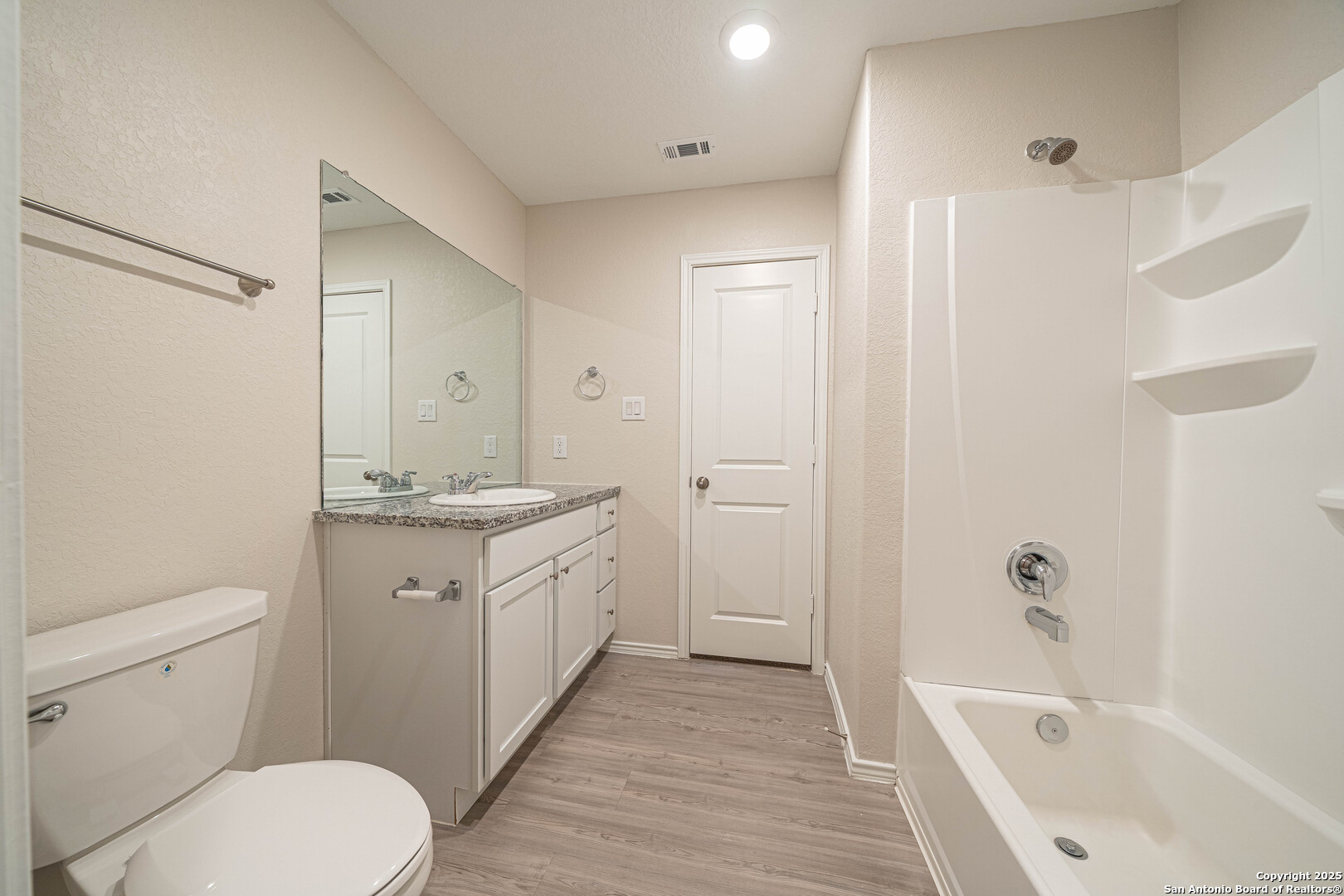 2818 Gustavo Drive Converse, TX 78109 - Photo 16 of 27 a bathroom with a granite countertop sink toilet and shower