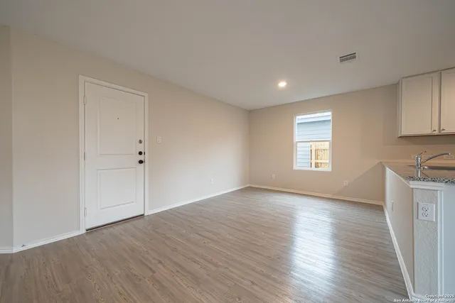 a kitchen with stainless steel appliances granite countertop a sink refrigerator and microwave