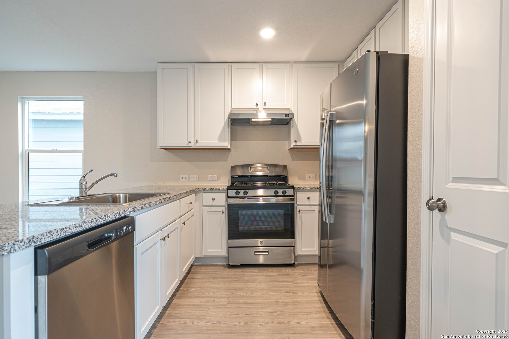 2818 Gustavo Drive Converse, TX 78109 - Photo 8 of 27 a kitchen with stainless steel appliances granite countertop a stove and a refrigerator