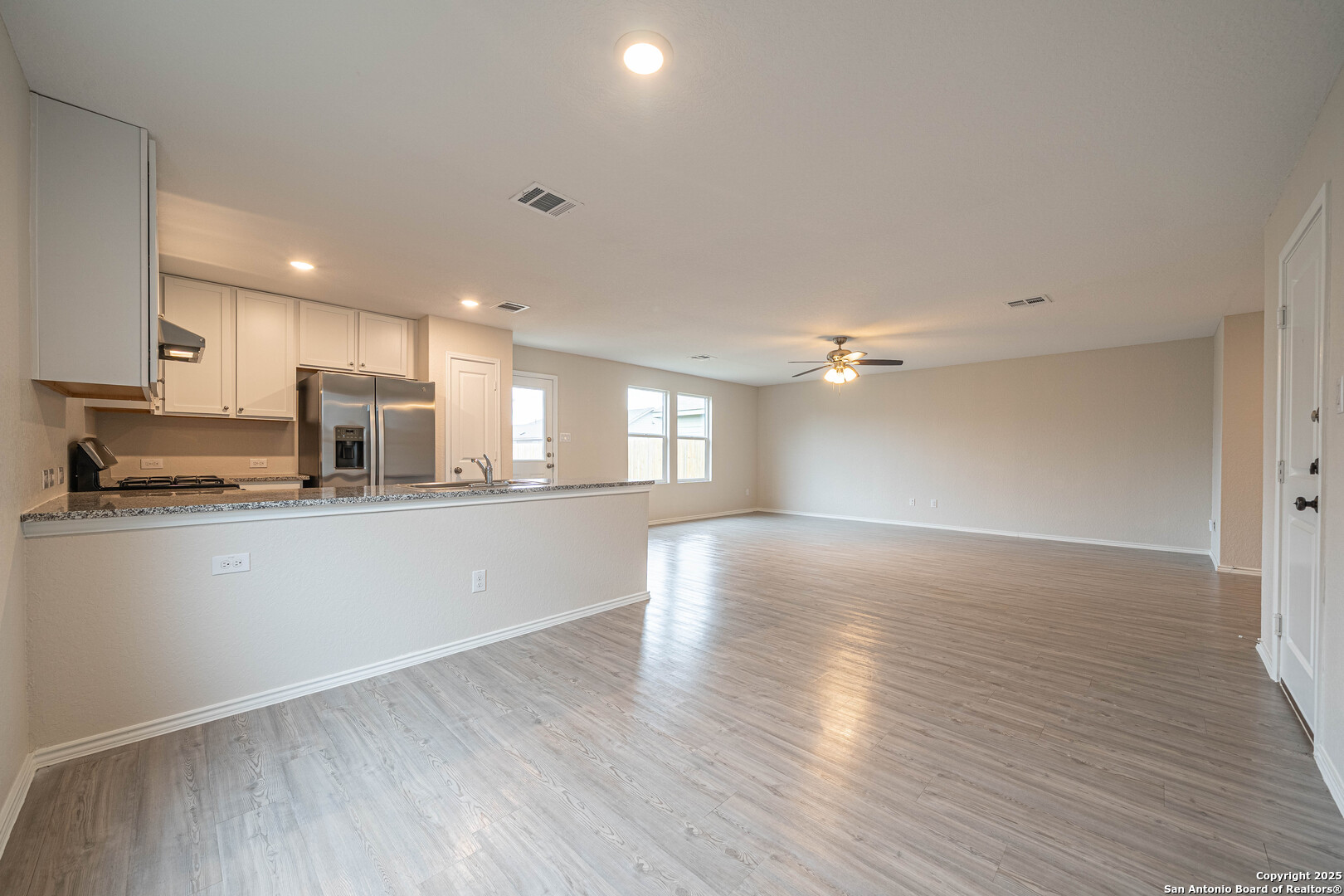 2818 Gustavo Drive Converse, TX 78109 - Photo 9 of 27 a view of kitchen with wooden floor and window