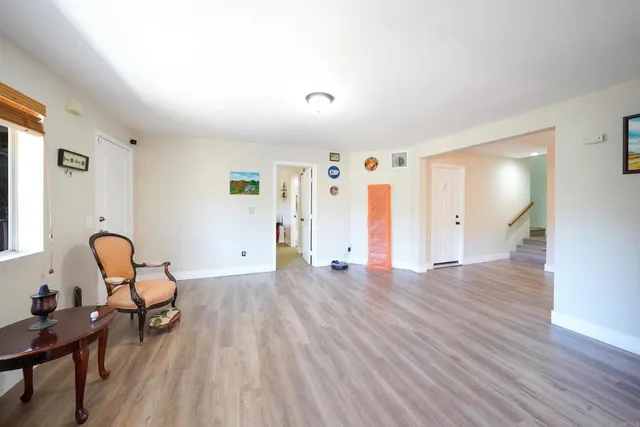 a view of a livingroom with furniture and hardwood floor