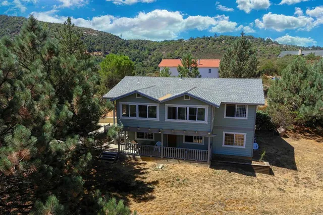 a aerial view of a house next to a yard