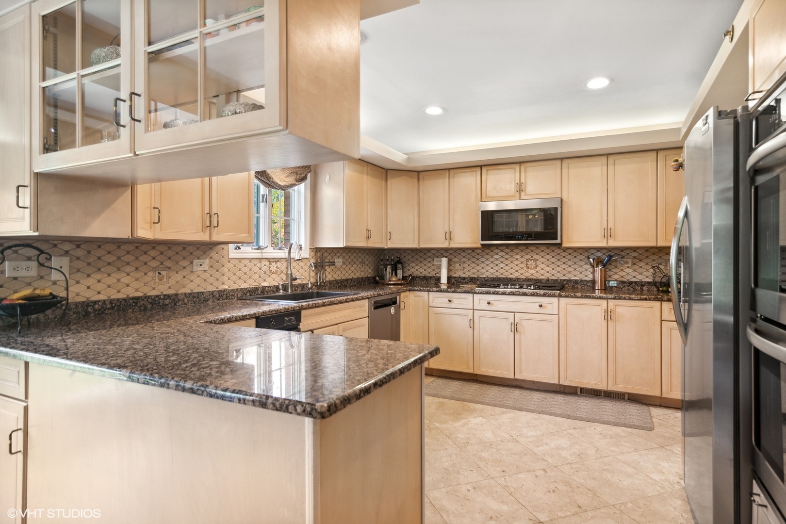 6207 Pine Tree Drive Long Grove, IL 60047 - Photo 14 of 49 a kitchen with stainless steel appliances granite countertop a sink a stove and a refrigerator