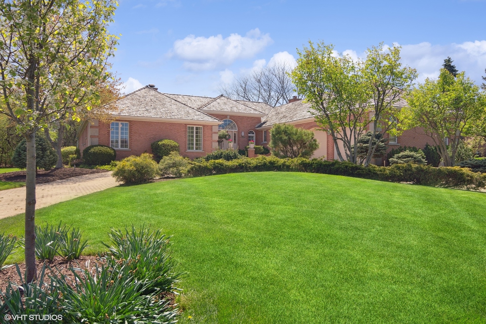 6207 Pine Tree Drive Long Grove, IL 60047 - Photo 4 of 49 a view of a brick house with a big yard and large trees