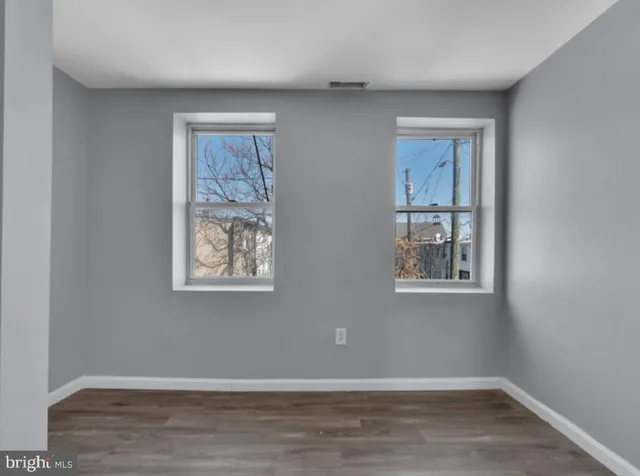 a view of a livingroom with wooden floor and a window