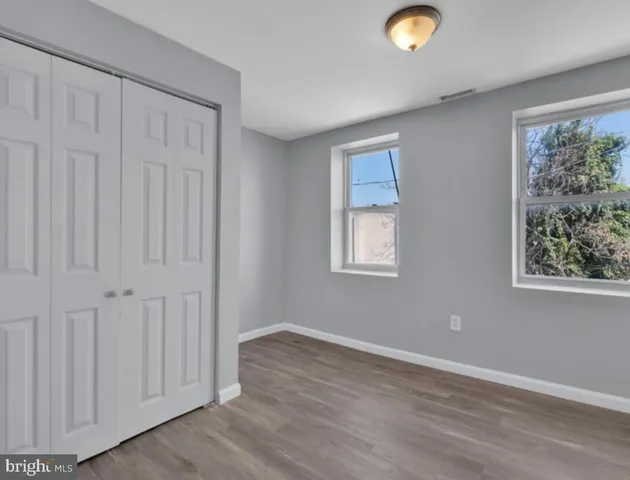 a view of balcony with a floor to ceiling window and wooden fence