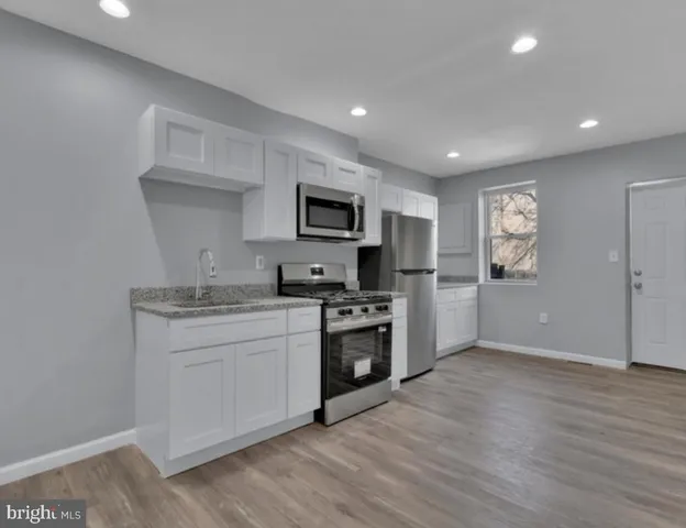 a kitchen with a sink cabinets and stainless steel appliances