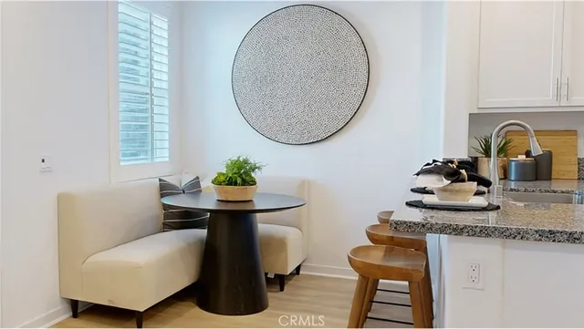 a dining room with furniture and a mirror