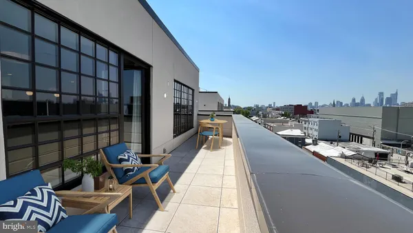a swimming pool with outdoor seating and city view