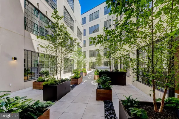 a building outdoor space with patio furniture and potted plants