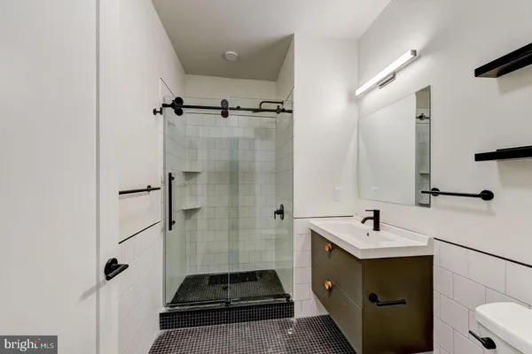 a bathroom with a double vanity sink mirror and shower