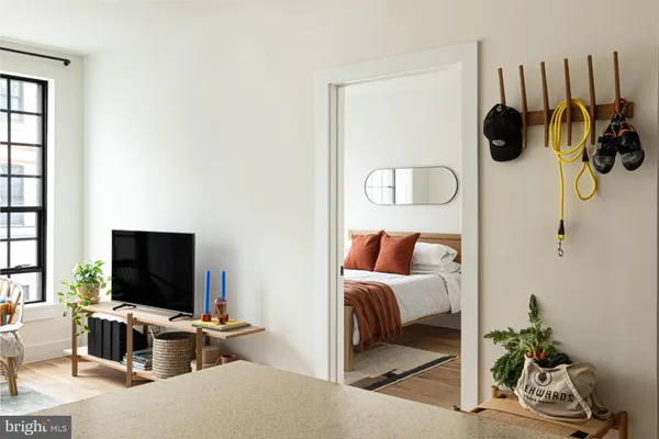 a bedroom with a bed and flat screen tv
