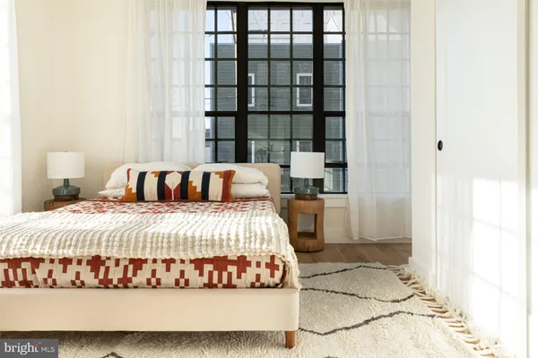 a bedroom with a bed and a window