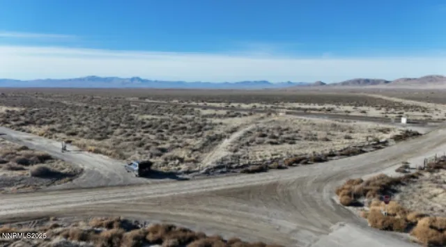 a view of a dry yard with wooden fence