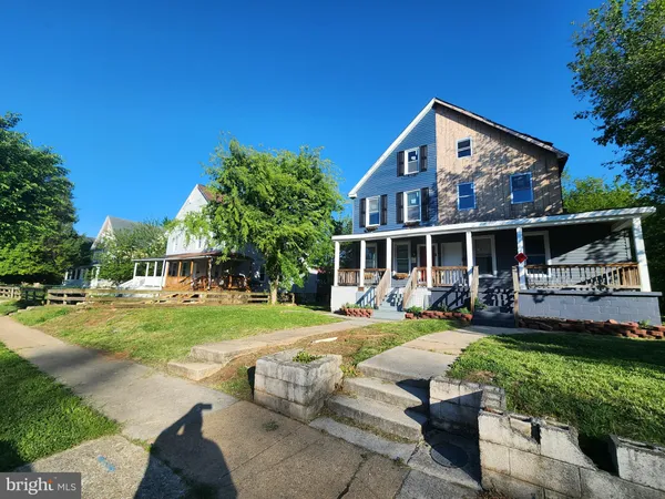 a view of a house with backyard porch and sitting area