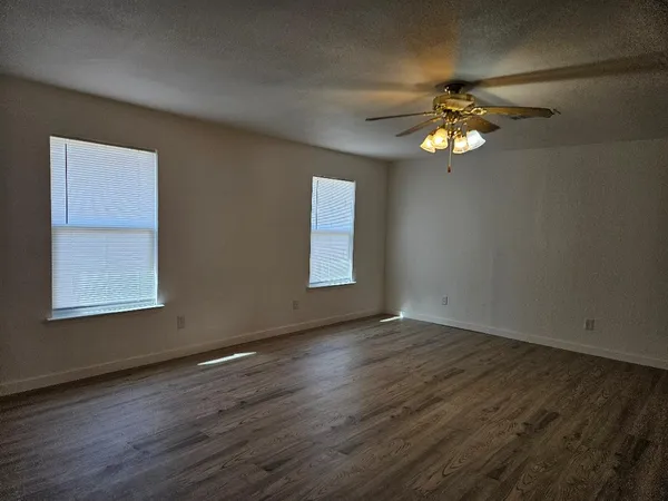 a view of a livingroom with a ceiling fan and window