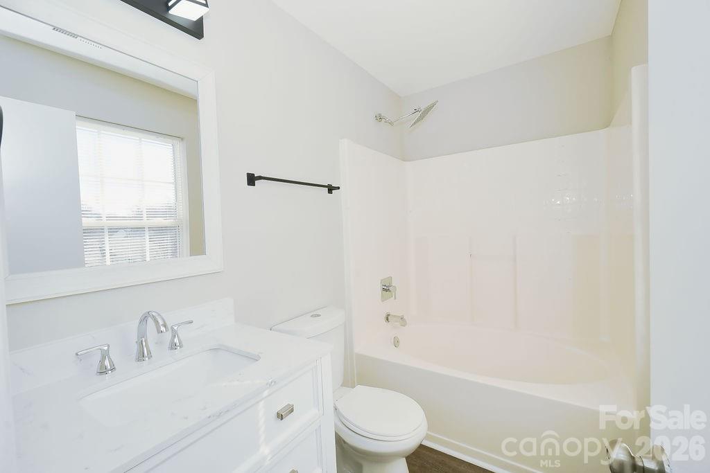 9614 Rau Court Charlotte, NC 28215 - Photo 13 of 21 a bathroom with a bathtub shower sink vanity mirror and toilet