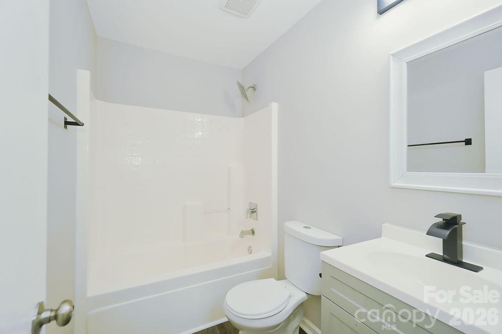 9614 Rau Court Charlotte, NC 28215 - Photo 15 of 21 a bathroom with a sink a toilet and shower