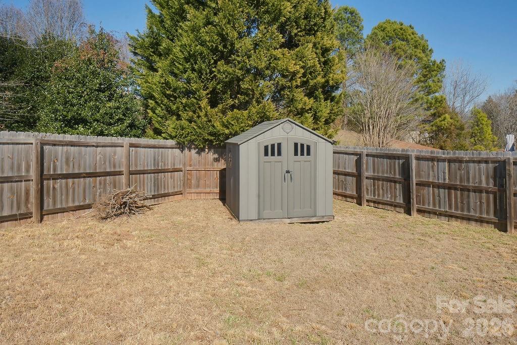 9614 Rau Court Charlotte, NC 28215 - Photo 19 of 21 a front view of a house with a yard and garage