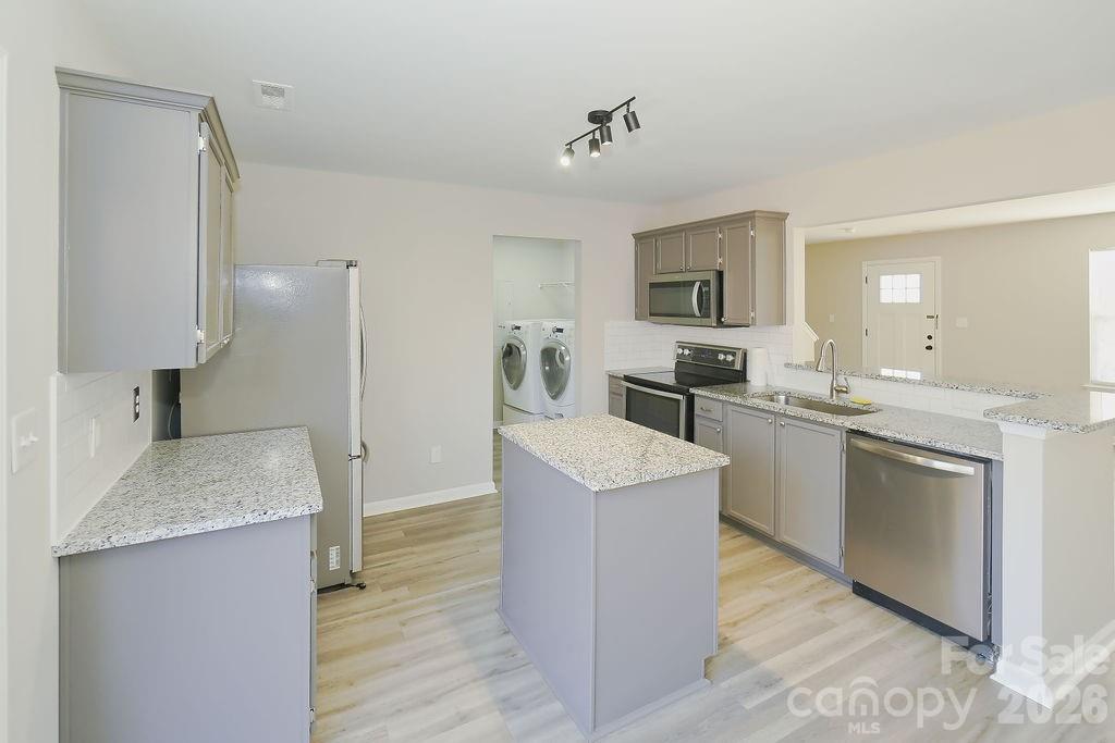 9614 Rau Court Charlotte, NC 28215 - Photo 6 of 21 a kitchen with a sink cabinets and refrigerator