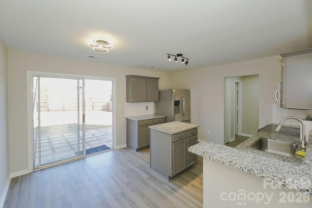 9614 Rau Court Charlotte, NC 28215 - Photo 8 of 21 a kitchen with a sink cabinets and wooden floor