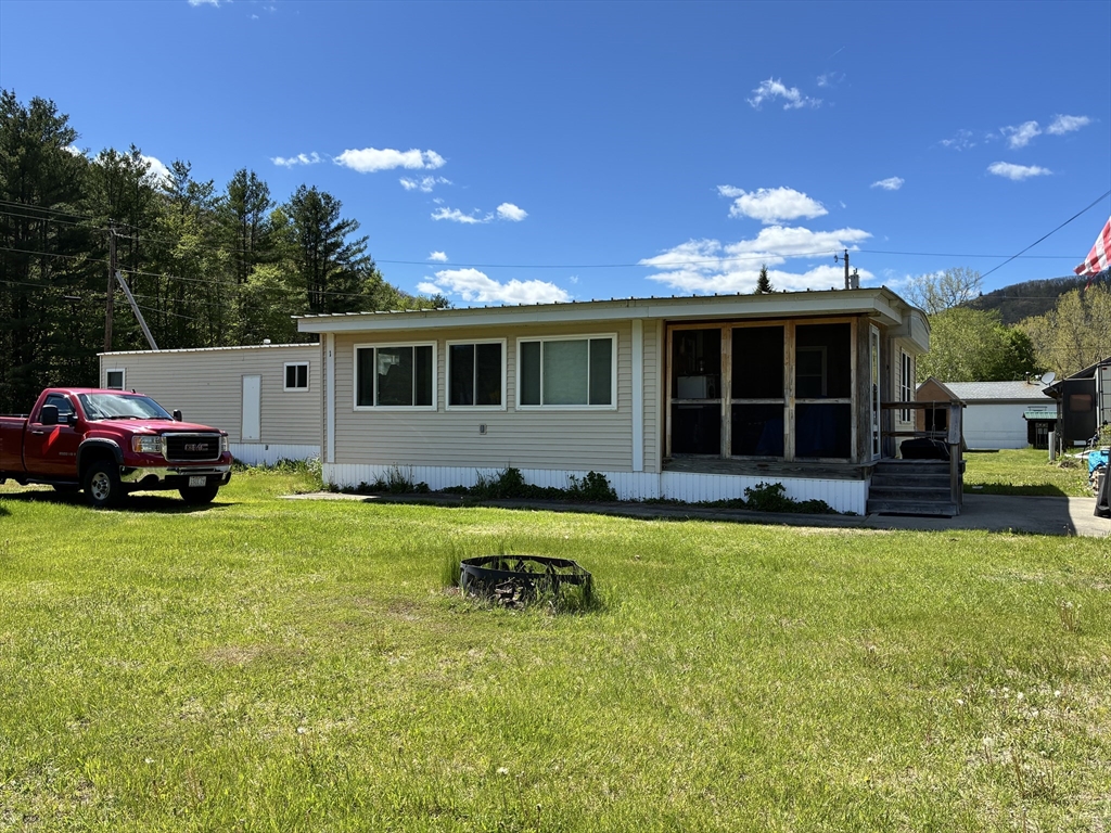 559 Tea Street, Unit 1 Charlemont, MA 01339 - Photo 1 of 14 a house view with a garden space