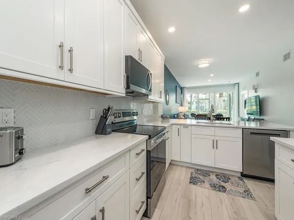 a kitchen with a sink cabinets and stainless steel appliances
