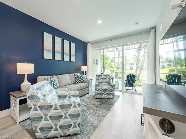 a living room with furniture and a large window