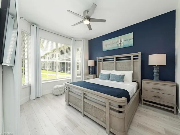 a spacious bedroom with a bed and a large window