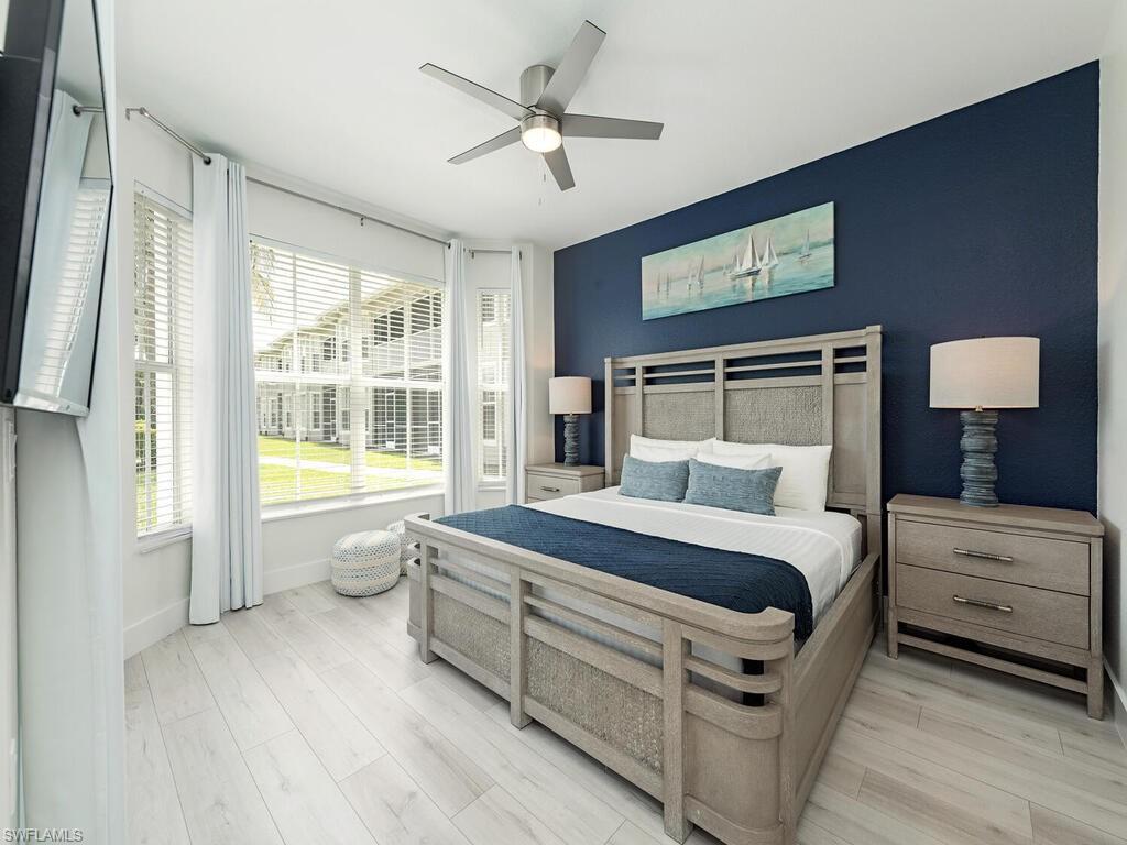 7970 Mahogany Run Lane, Unit 216 Naples, FL 34113 - Photo 7 of 29 a spacious bedroom with a bed and a large window
