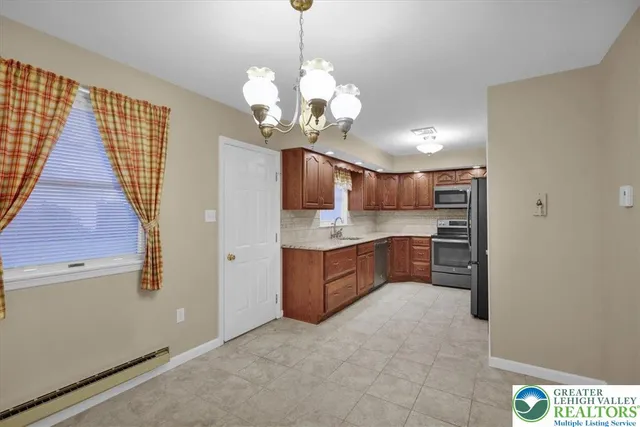 a spacious bathroom with a granite countertop sink a mirror and a bathtub