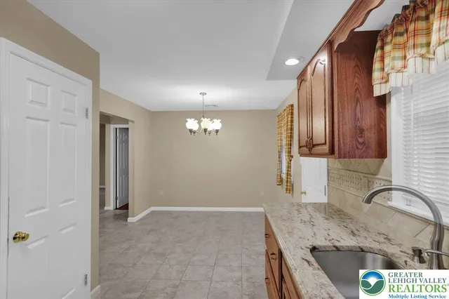 a kitchen with granite countertop a sink and a stove