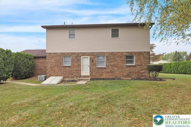 a view of a house with a yard and garage