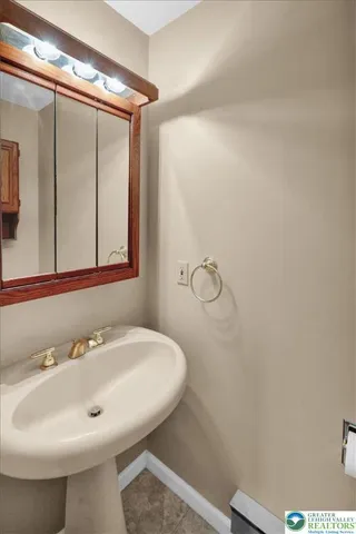 a bathroom with a sink and mirror