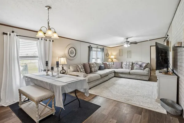 a living room with furniture and a chandelier